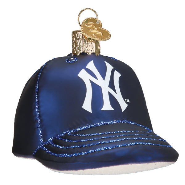 Navy blue baseball cap ornament with white NY logo and blue glitter brim detail, gold metal top cap and loop hanger