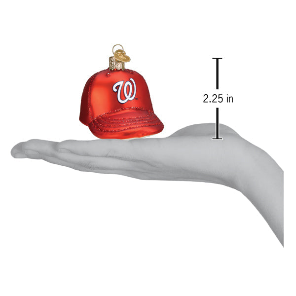 Red baseball cap ornament with "W" logo displayed in open hand, showing 2.25-inch size scale