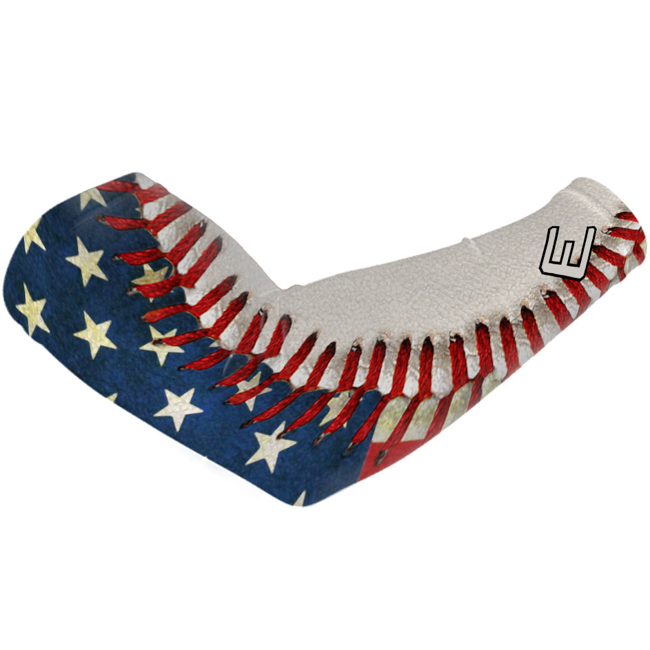 Pastime compression arm sleeve with American flag and baseball design, featuring navy blue with cream stars and red stripes on the upper arm.