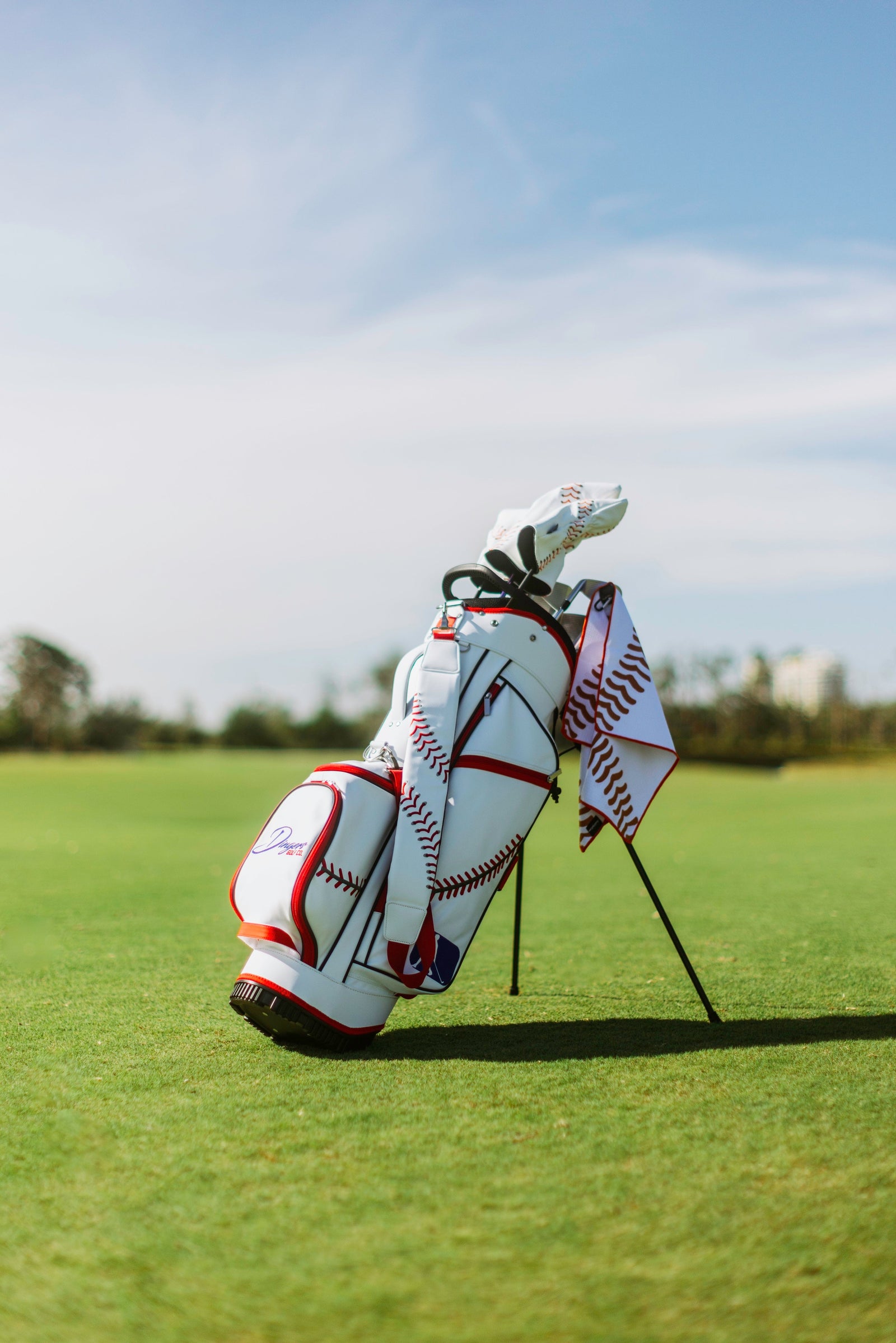 Baseball-inspired PU leather golf bag with red stitching, six pockets, and stand legs.