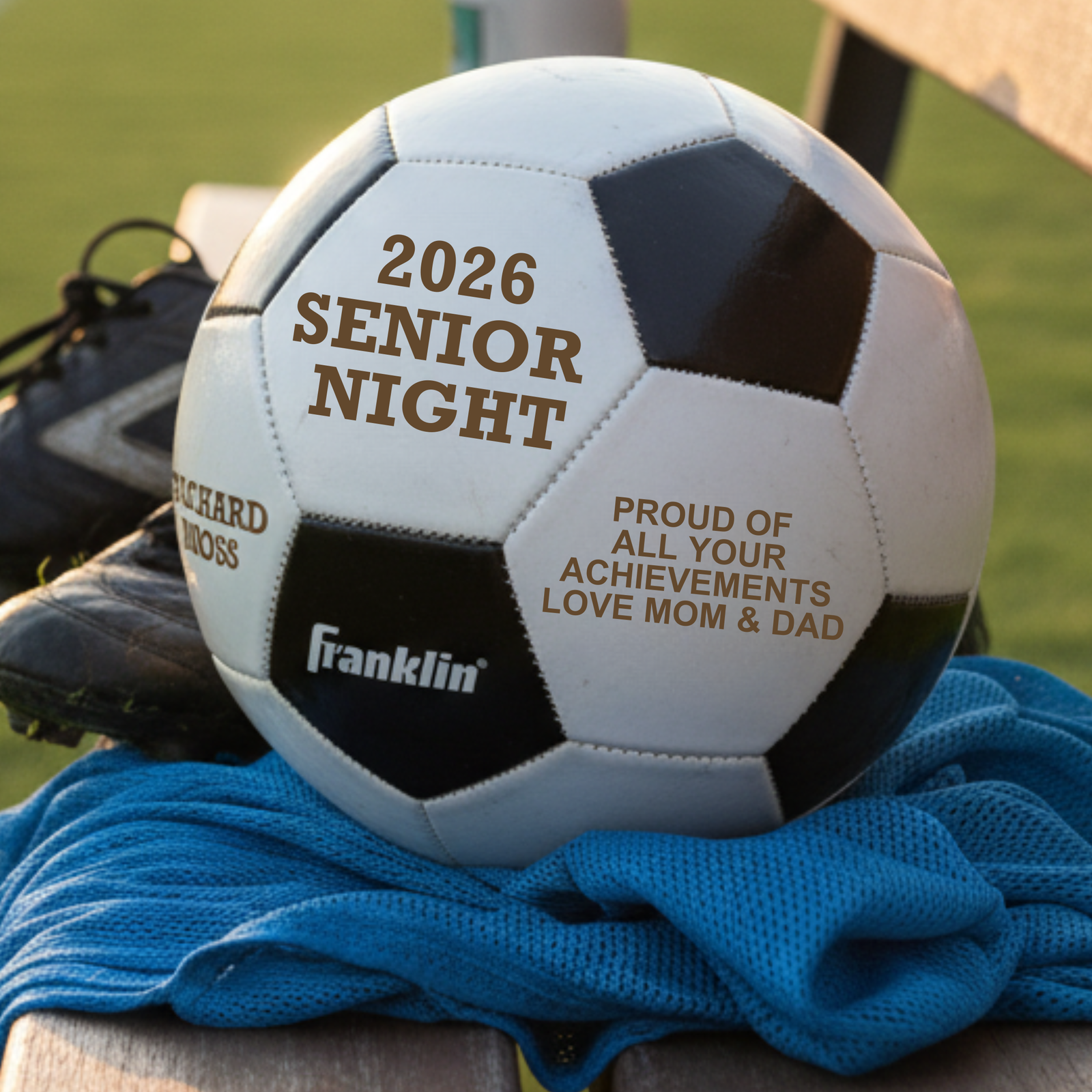 Personalized senior night soccer ball in synthetic leather with warm brown laser engraving across three panels showing the player's name, number, and team