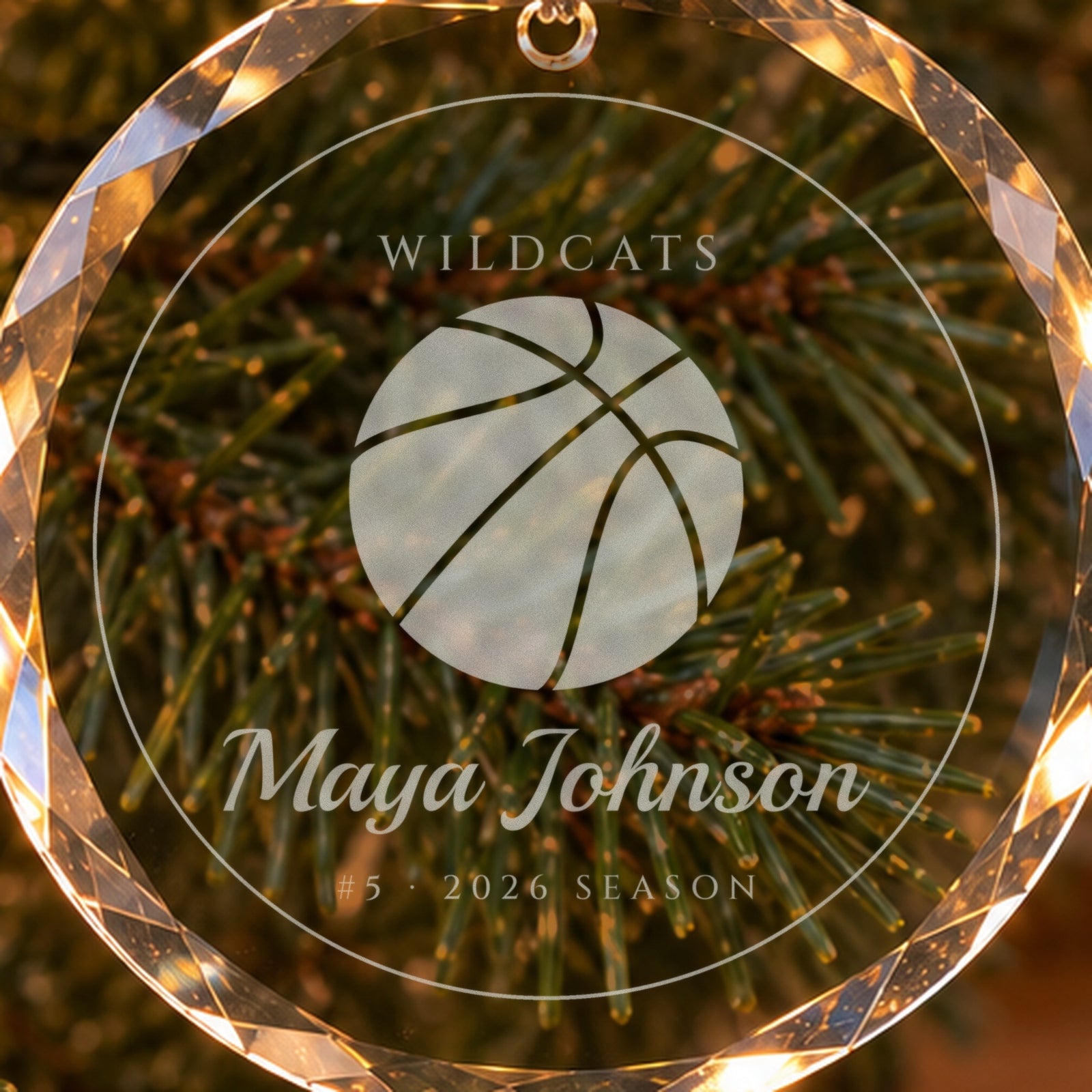 Close-up of the frosted engraving on the basketball ornament: a big basketball, WILDCATS, Maya Johnson, #5 · 2026 SEASON