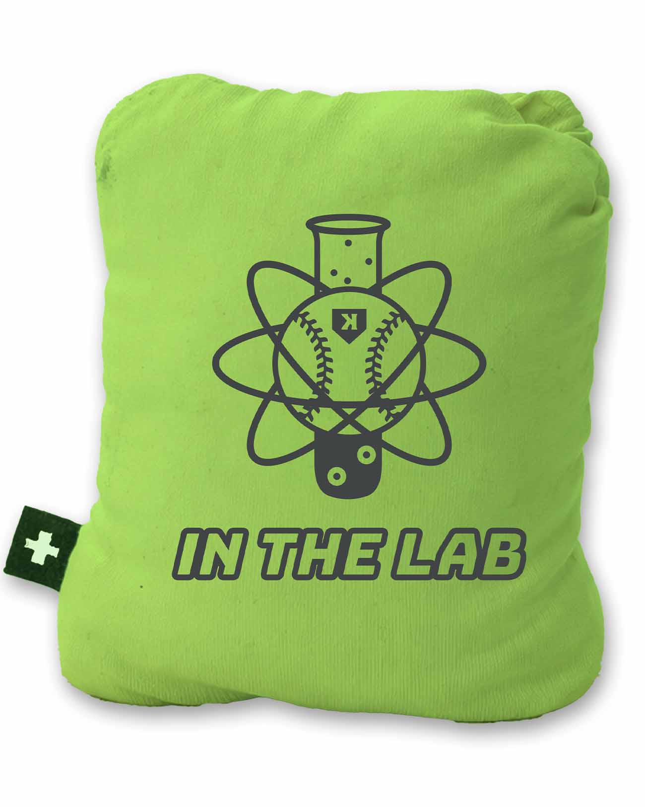 Bright lime-green rosin bag with dark navy graphic showing baseball inside atom symbol and text "IN THE LAB" below, small white cross logo patch visible on left side