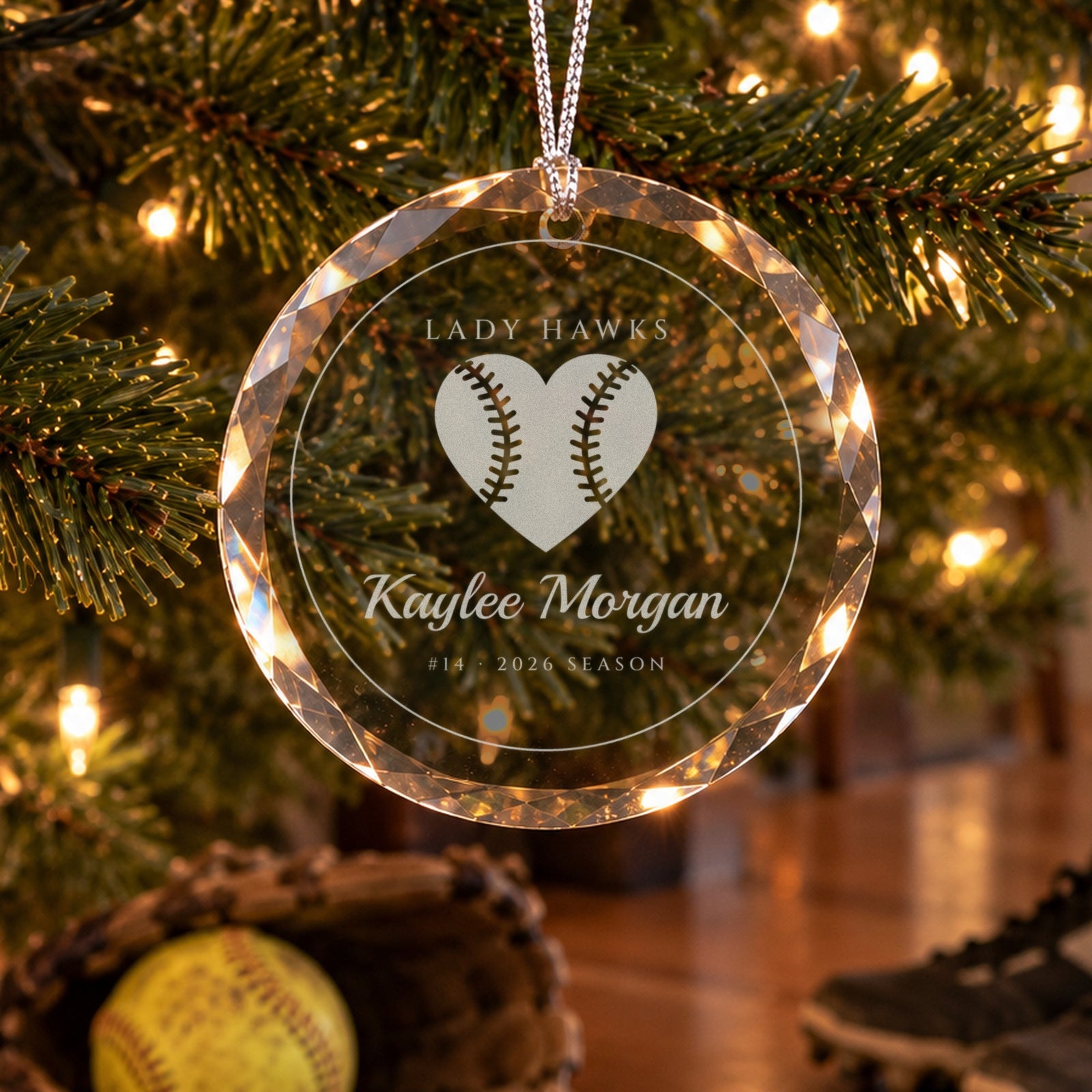 Personalized softball ornament in faceted glass on a Christmas tree, engraved with a softball heart, LADY HAWKS, Kaylee Morgan, #14 · 2026 SEASON