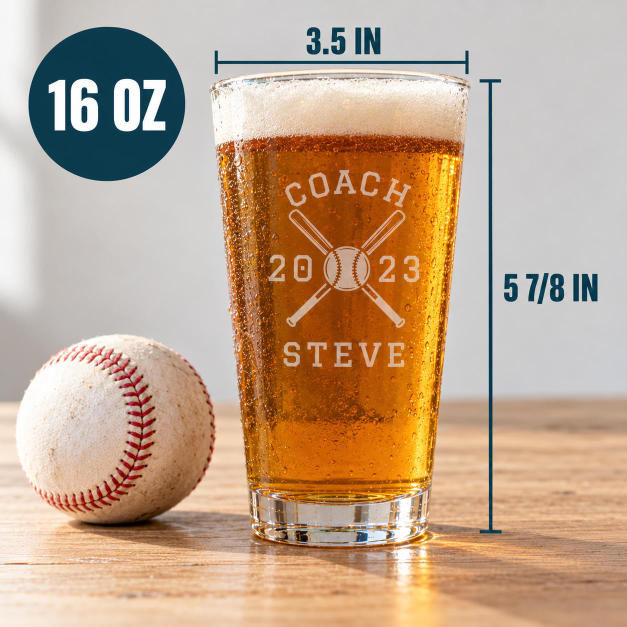 Team Roster Baseball Coach Pint Glass size chart: 16 oz, 3.5 inches across the rim and 5 7/8 inches tall, engraved COACH 2023 STEVE, shown next to a baseball