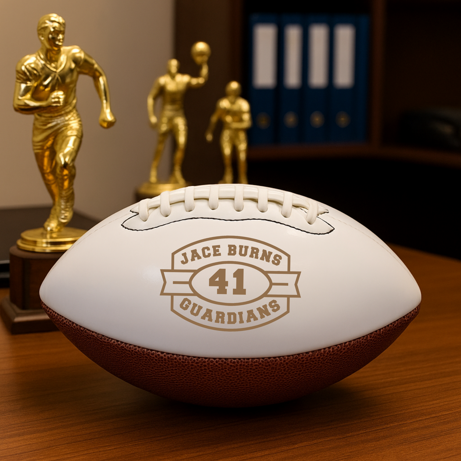 Custom keepsake football with a laser-engraved white panel inspired by a championship trophy, personalized with the player's name, jersey number, and team
