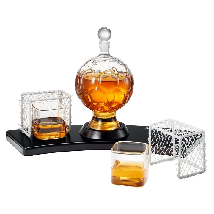 World Cup Decanter Set displaying spherical decanter with stopper, two rocks glasses with mesh goalpost holders, and black display base filled with amber liquor