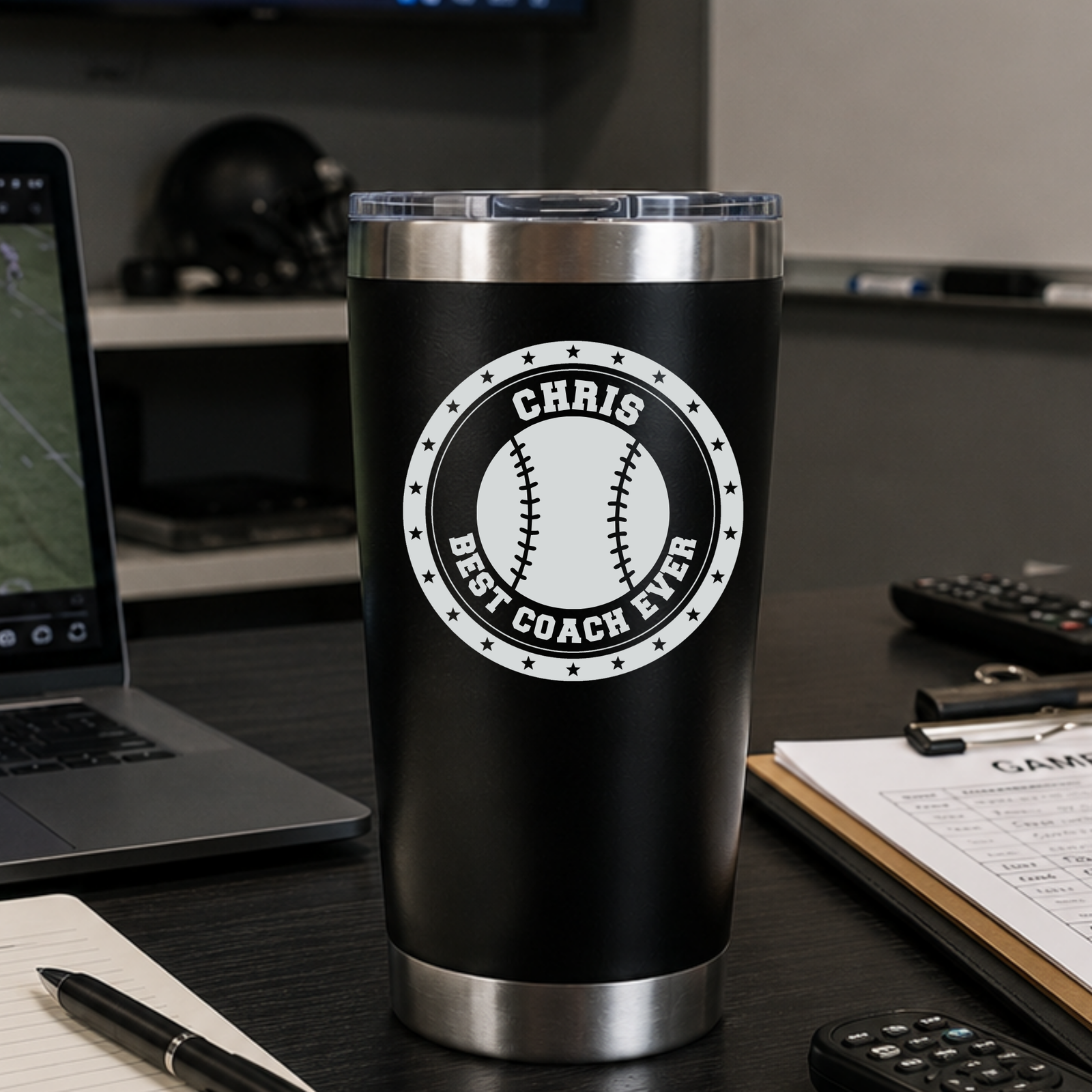 Personalized baseball coach tumbler engraved with CHRIS and BEST COACH EVER, sitting on a coach's desk, a 20oz insulated baseball coach gift