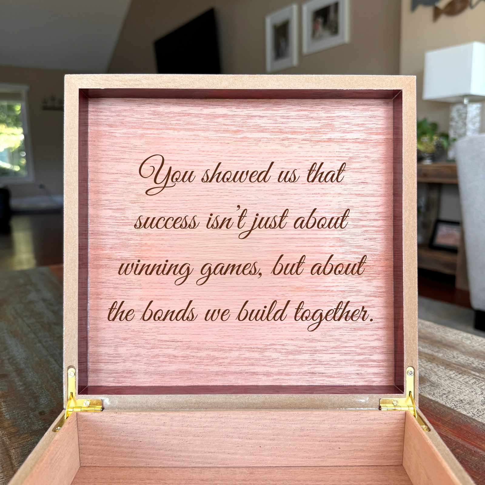 Cherry baseball coach keepsake box open showing a sample engraved message 'You showed us that success isn't just about winning games, but about the bonds we build together' inside the lid