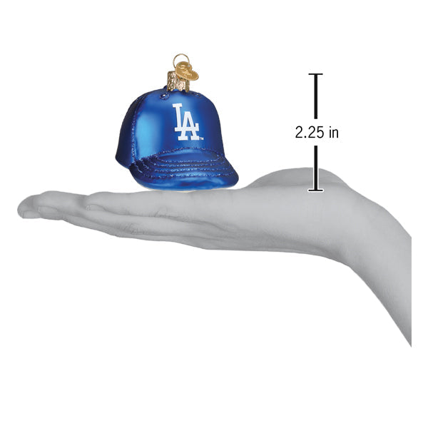 Blue baseball cap ornament with LA logo displayed in palm of hand, showing 2.25 inch height measurement