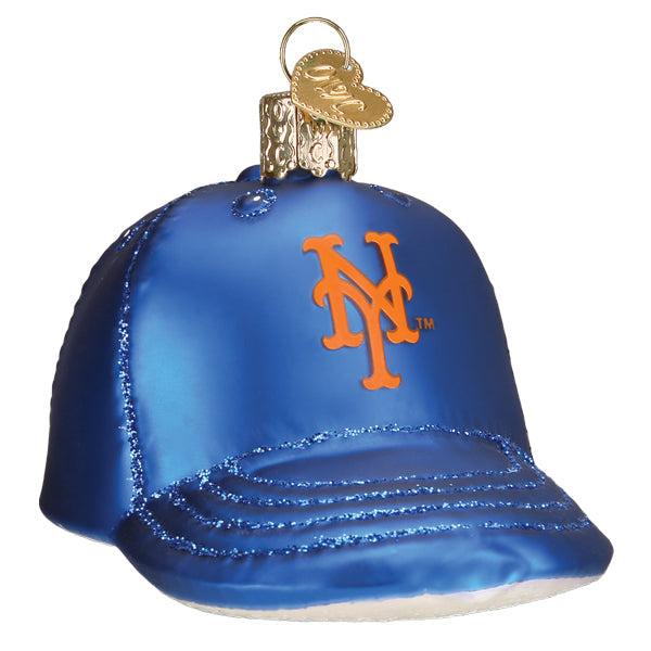 Blue glass baseball cap ornament with orange Mets logo and glittered bill detail, featuring gold metal hanger loop on crown