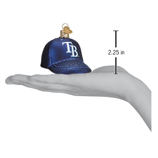 Navy baseball cap ornament with white TB logo shown in palm of hand, measuring 2.25 inches tall, with gold string loop for hanging