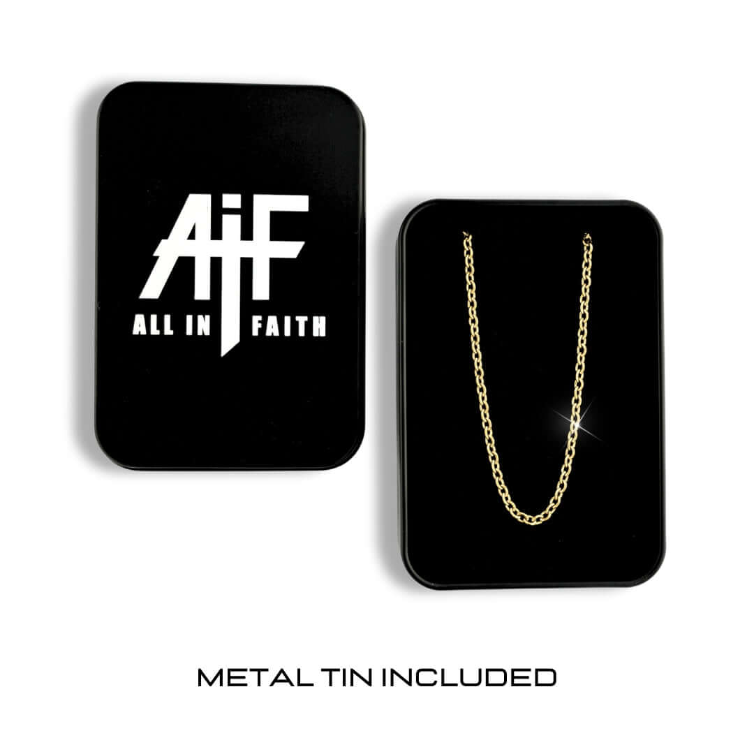 Gold-tone stainless steel cable chain displayed on black packaging with All In Faith branding and metal tin included