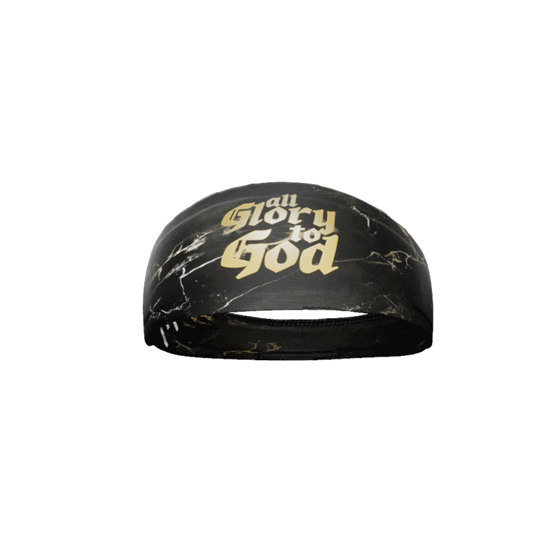 Top-down view of the rolled All Glory To God headband showing the gold gothic lettering across the black marble print