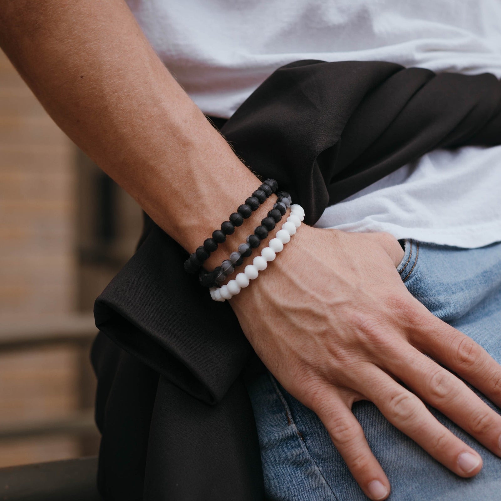 Black and grey baseball bracelet with cross bead, durable silicone design.