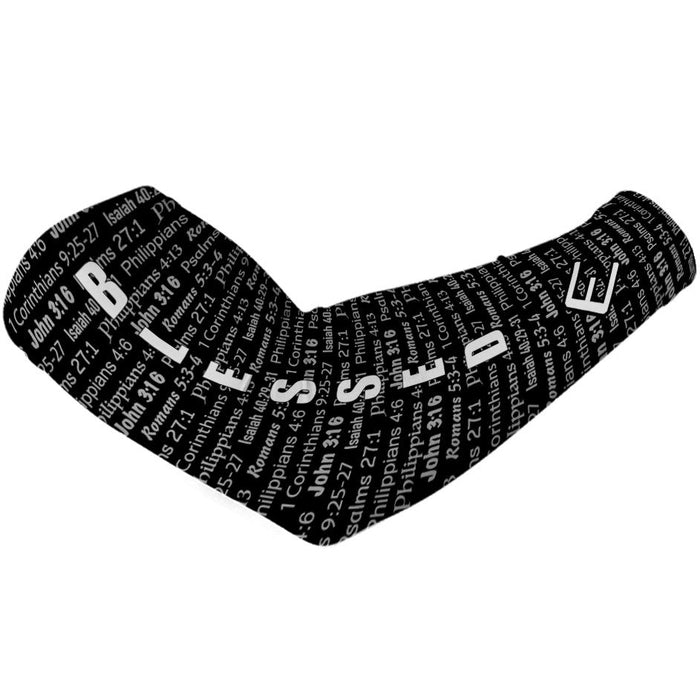 Black compression arm sleeve with white text featuring scripture and religious passages throughout the fabric, displayed on flat surface.
