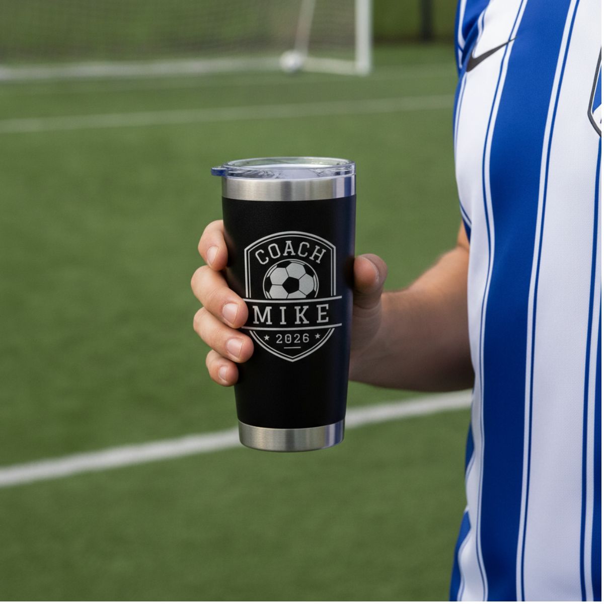 Personalized soccer coach tumbler with the coach's name and a soccer design engraved on the front and the full team roster engraved on the back
