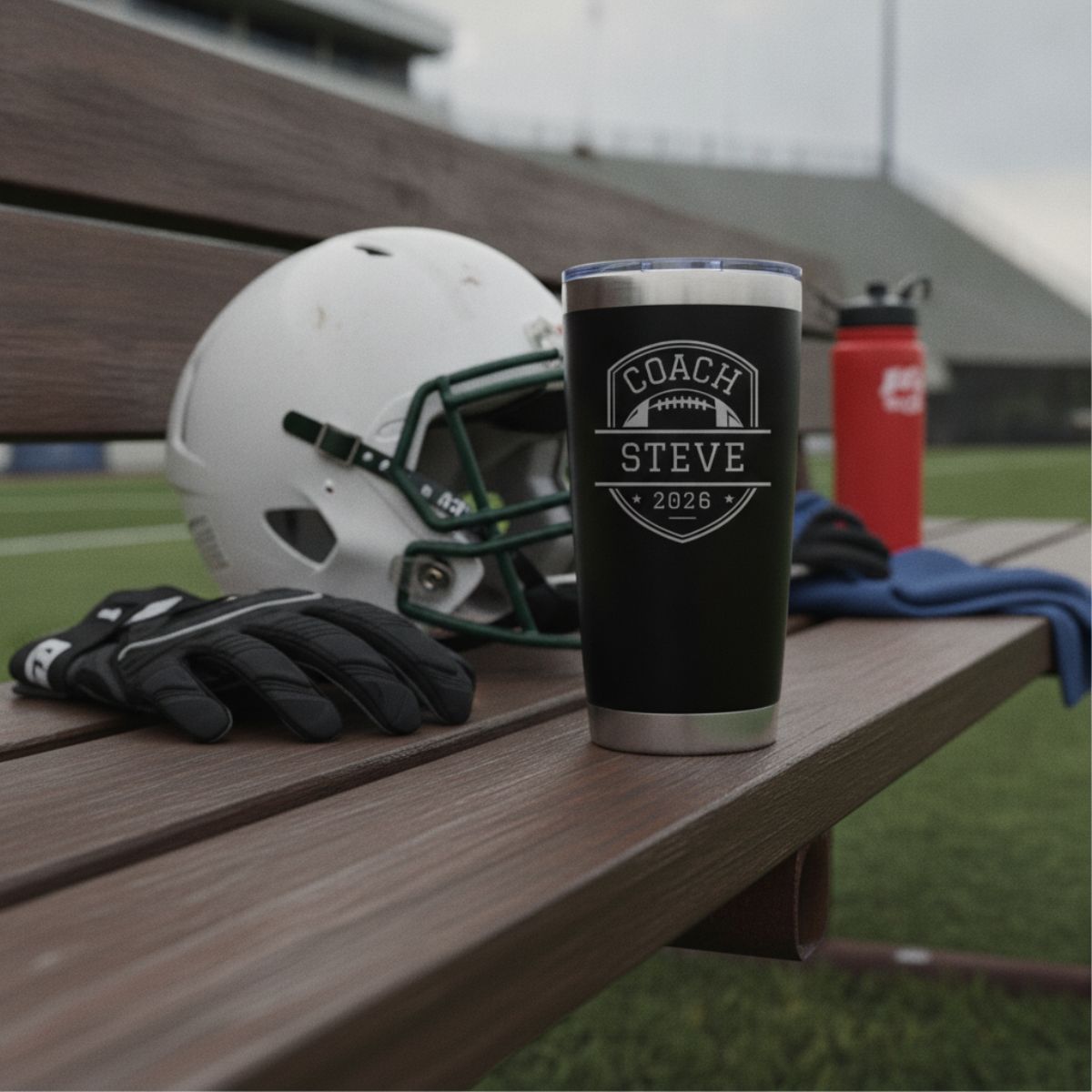 Personalized football coach tumbler with the coach's name and a football design engraved on the front and the full team roster engraved on the back