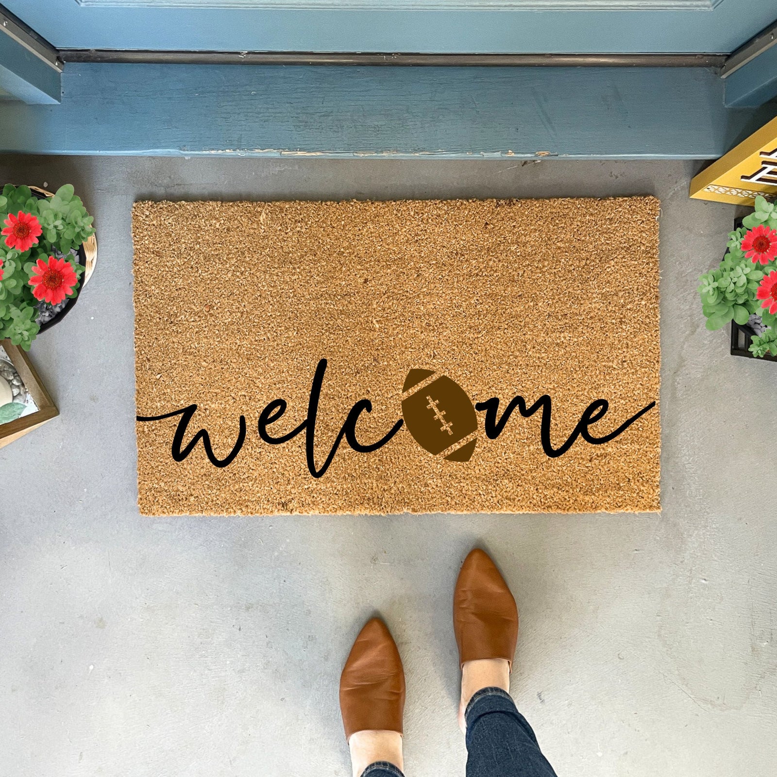 Cork doormat with "welcome" text and football graphic in black and tan designs