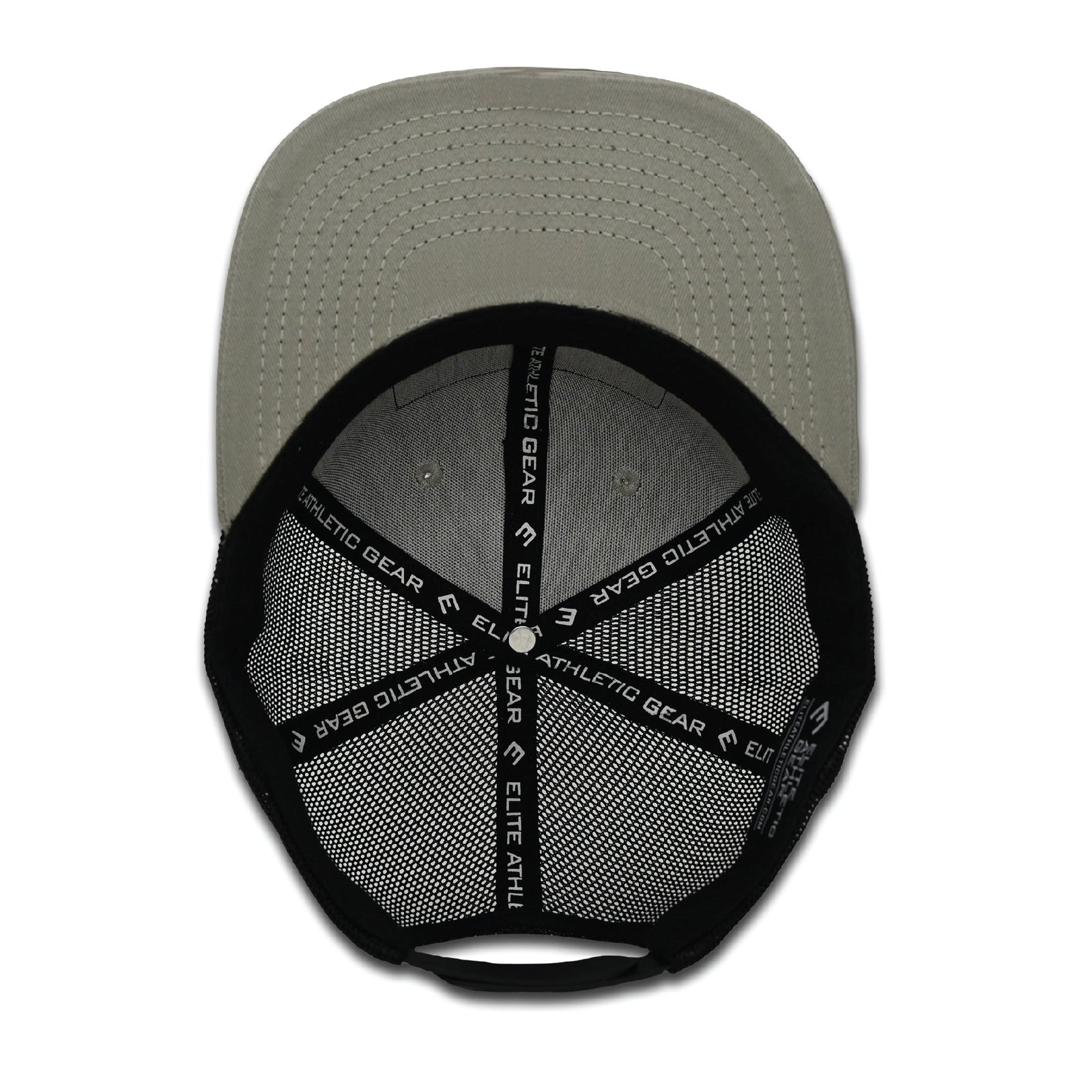 Grey and black trucker hat with mesh panels, flat brim, and PVC USA flag patch on front, displayed from overhead view showing snapback closure and inner mesh detail