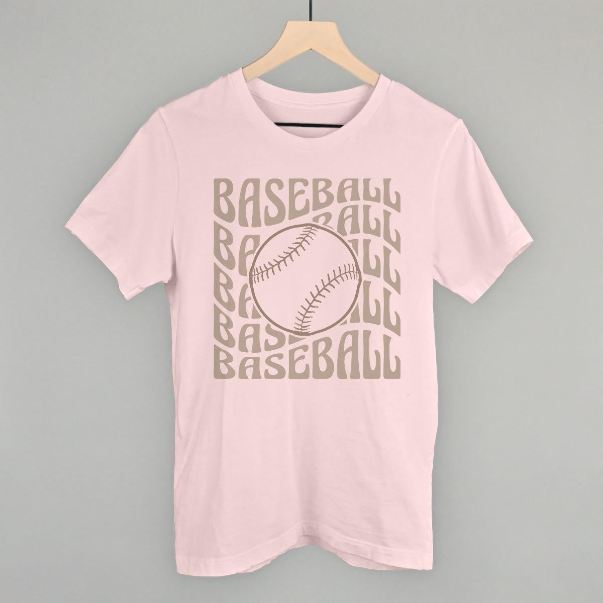 Soft pink Bella+Canvas tee with the Baseball Groovy Wave design in stacked retro lettering and a baseball center, printed in cream ink