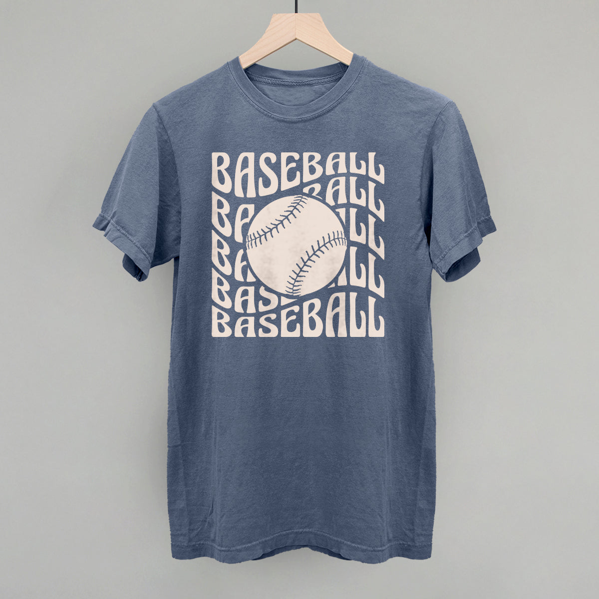 Blue jean Comfort Colors vintage tee with the Baseball Groovy Wave design in stacked retro lettering and a baseball center, printed in cream ink