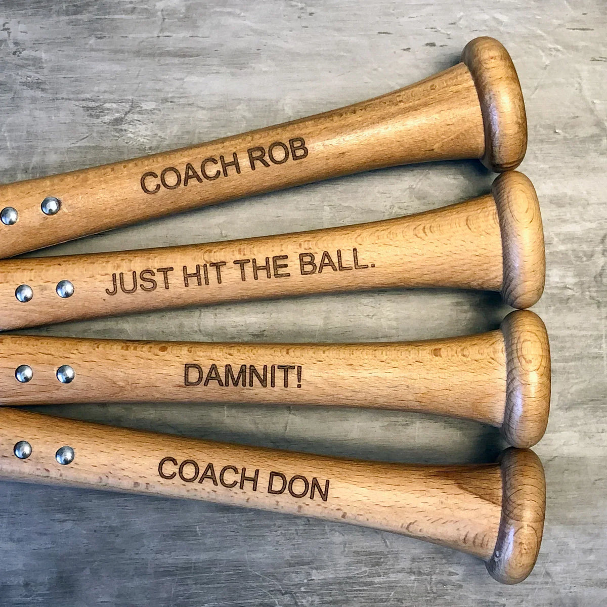 Personalized Baseball Bat Bottle Opener shown opening a bottle