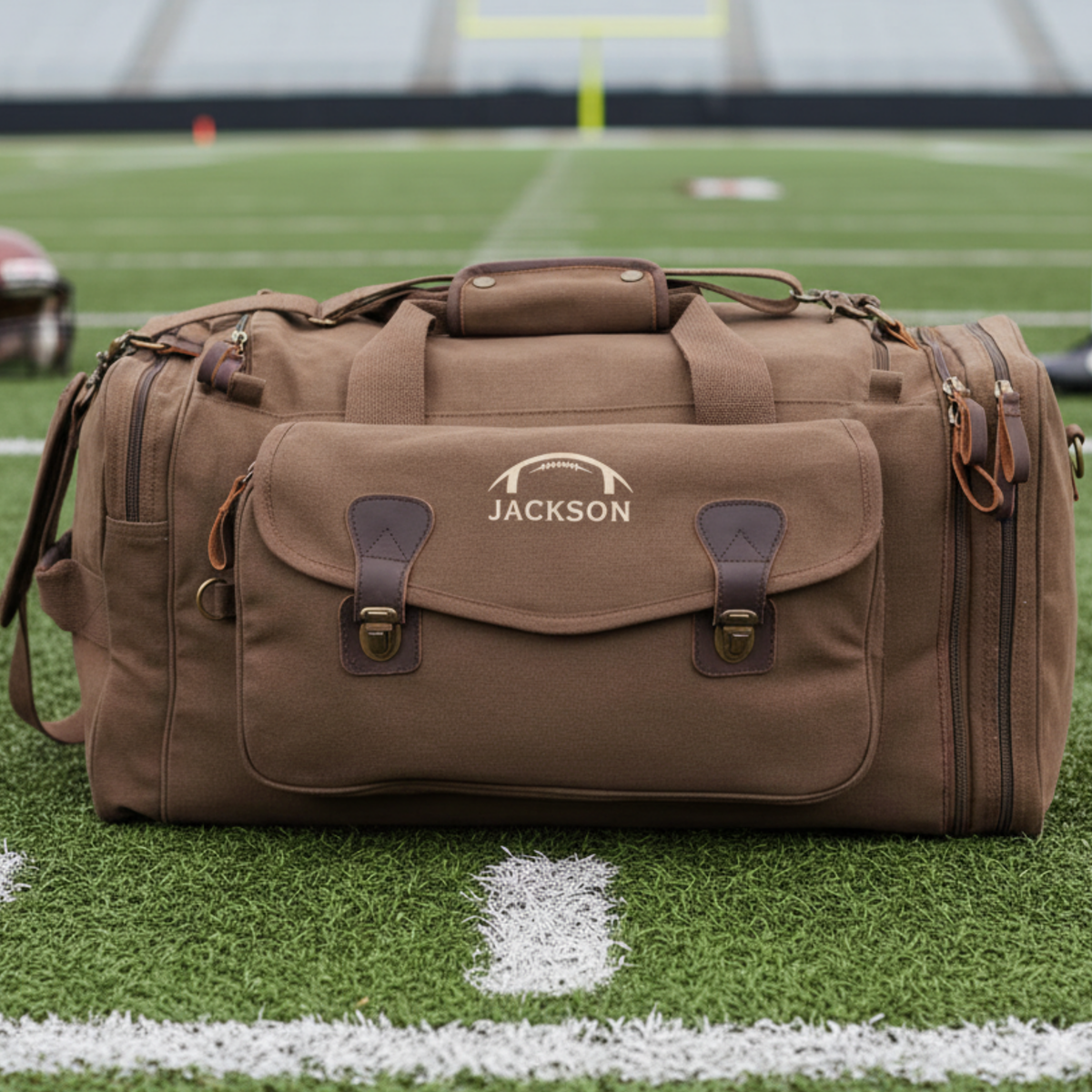 Personalized senior football duffle bag in heavyweight canvas with leather accents and an embroidered football with his name or jersey number stitched underneath