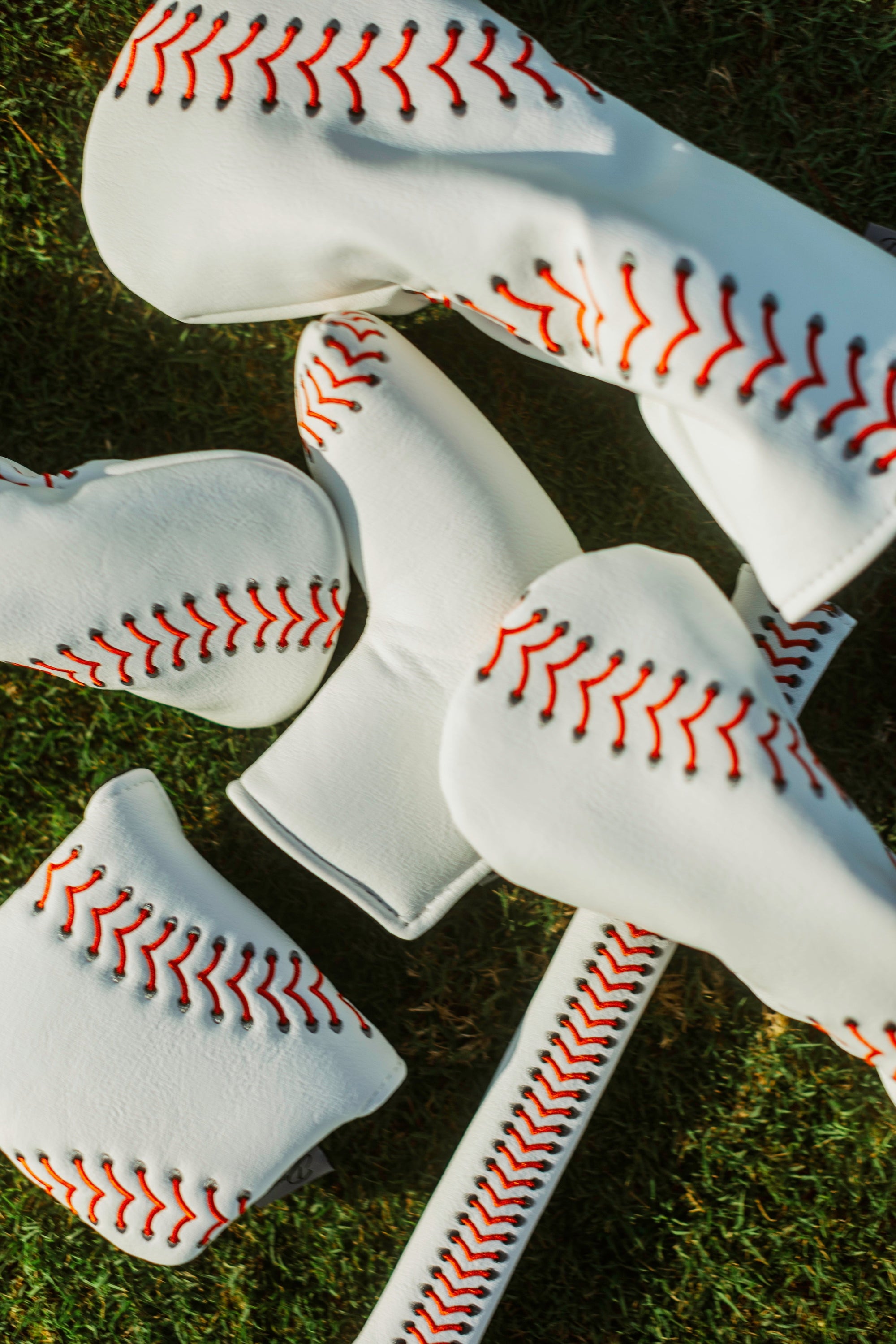 Baseball seam golf headcover with red stitching, PU leather, for driver, wood, or fairway clubs.