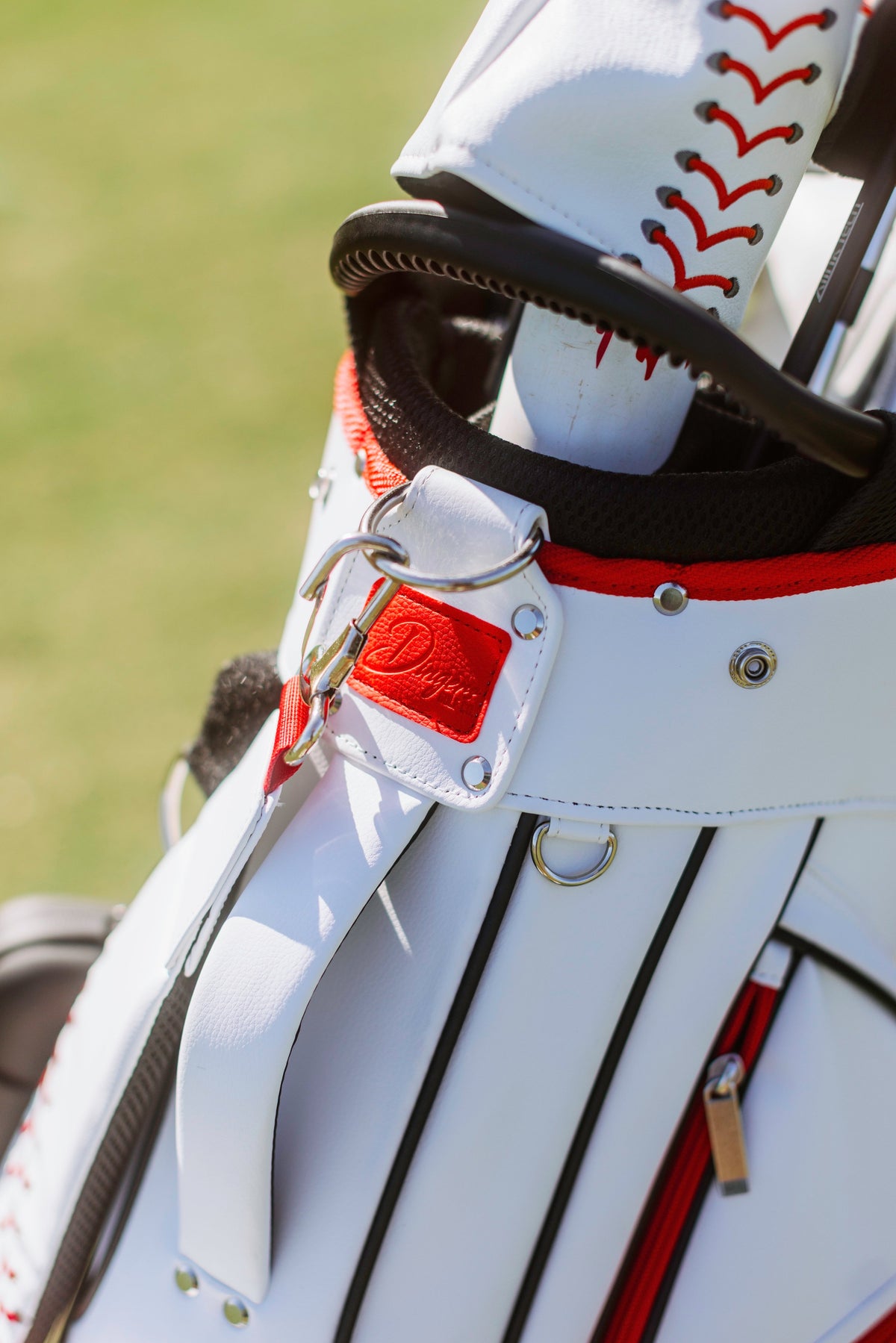Baseball-inspired PU leather golf bag with red stitching, six pockets, and stand legs.