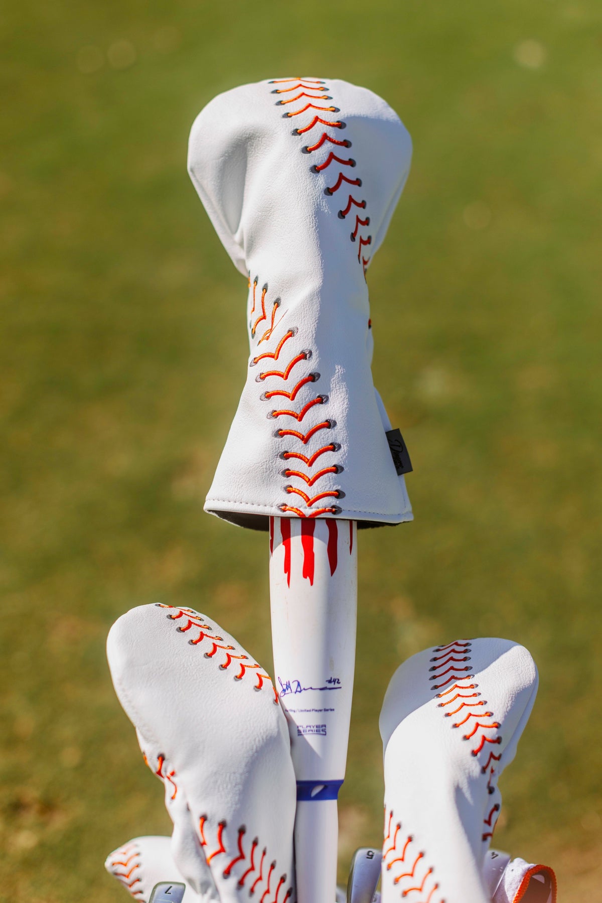 Baseball seam golf headcover with red stitching, PU leather, for driver, wood, or fairway clubs.