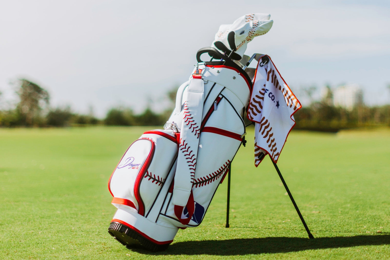 Baseball-inspired PU leather golf bag with red stitching, six pockets, and stand legs.