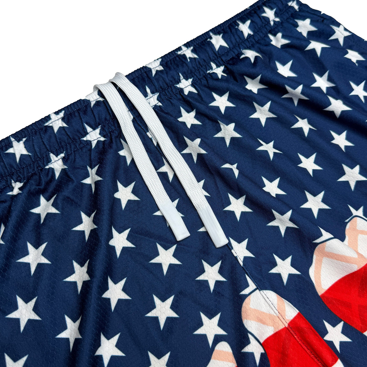 Navy shorts with white stars and red stripe pattern, showing elastic waistband with white drawstrings and deep side pocket detail