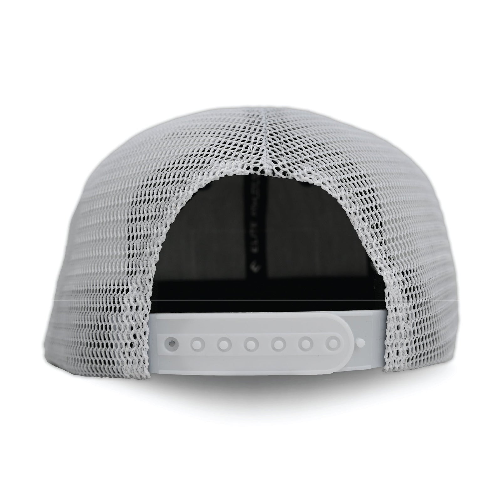 White mesh trucker hat with navy brim and front panel, viewed from back showing adjustable snapback closure with snap buttons