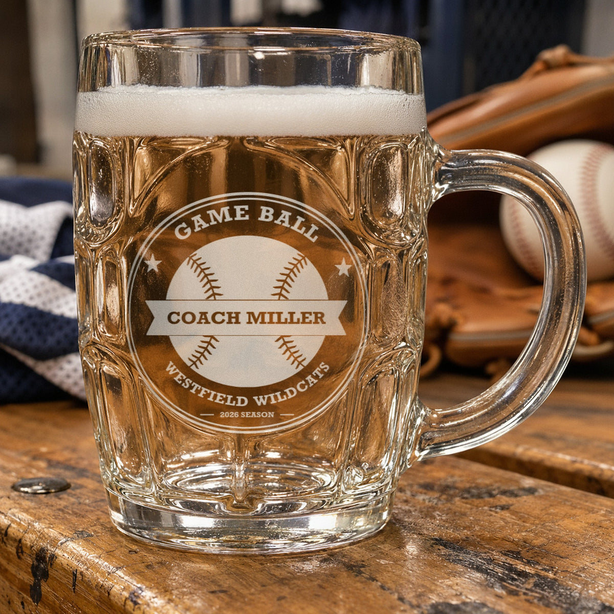 Personalized baseball coach beer stein beside a leather glove and a baseball, frosted engraving reading Game Ball, Coach Miller and Westfield Wildcats