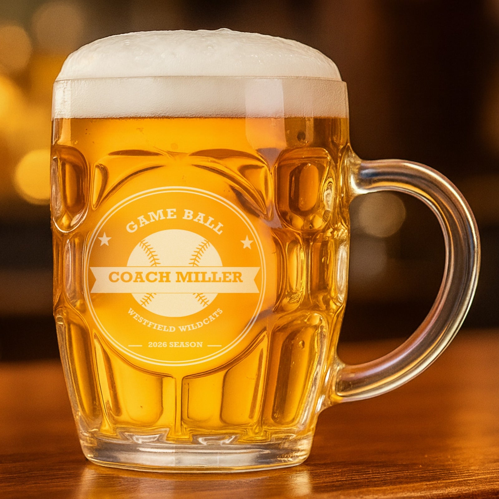 Game Ball crest with stitched baseball seams and the name Coach Miller etched into a 20 oz dimpled beer stein filled with golden lager