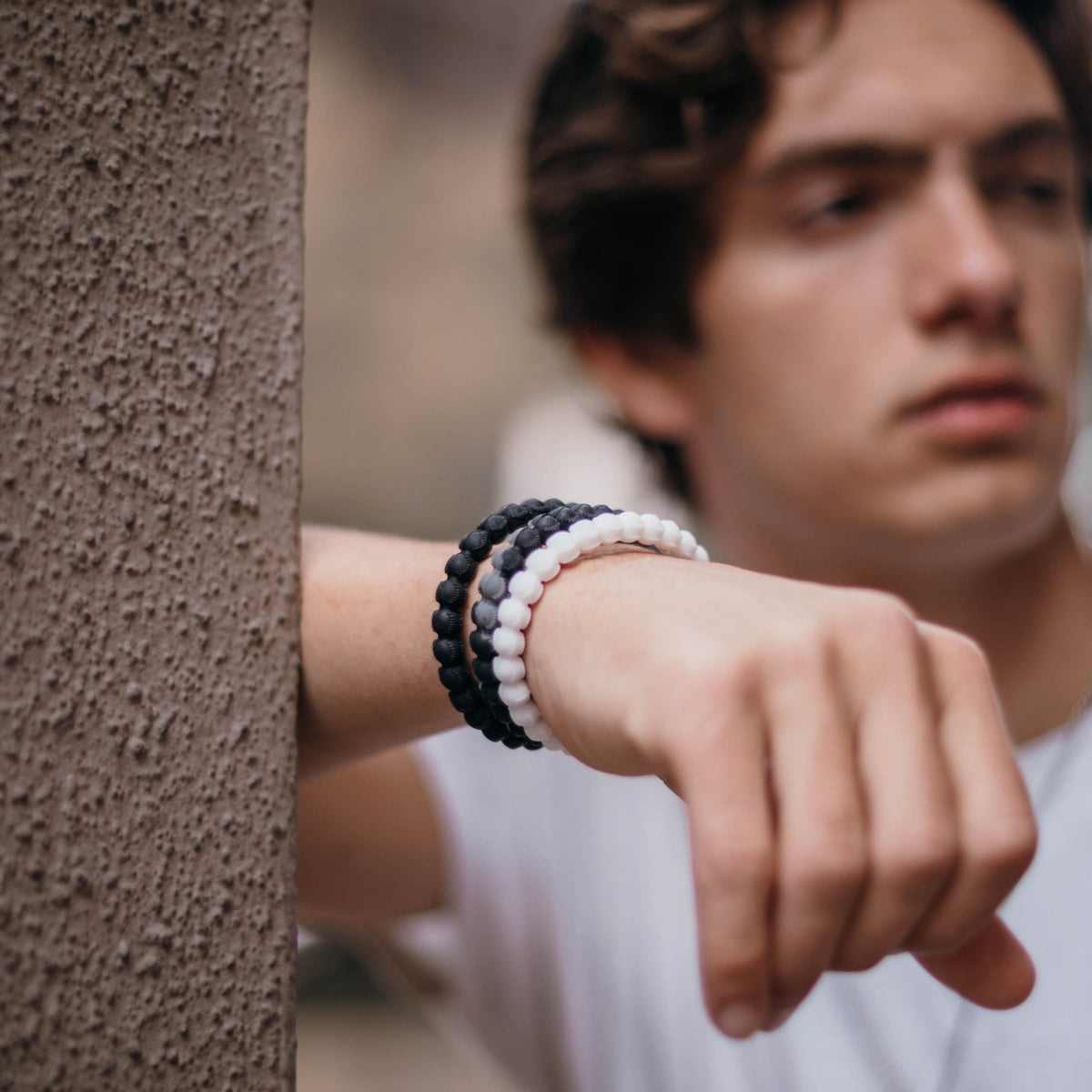 Black and grey baseball bracelet with cross bead, durable silicone design.