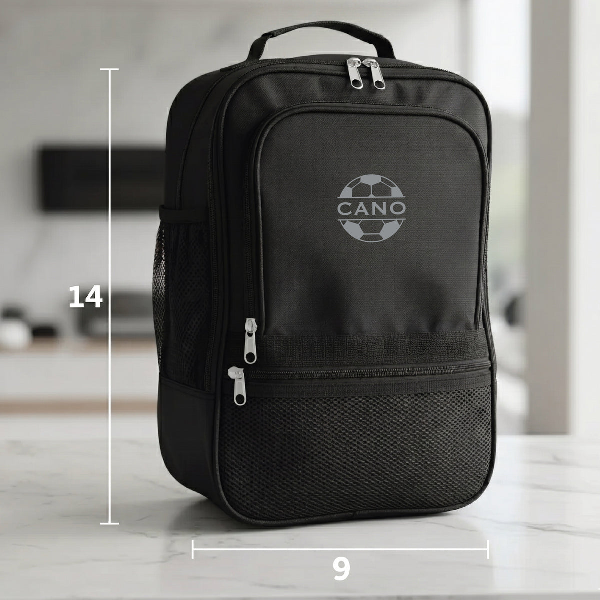 Black duffle bag with sample engraving "CANO" and soccer ball design, showing dimensions 14 inches tall by 9 inches wide