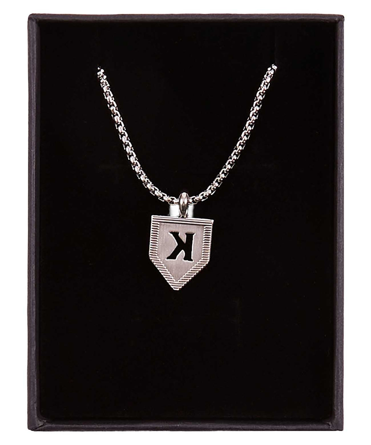 Silver pendant necklace with shield-shaped pendant engraved with sample letter K, displayed in black presentation box