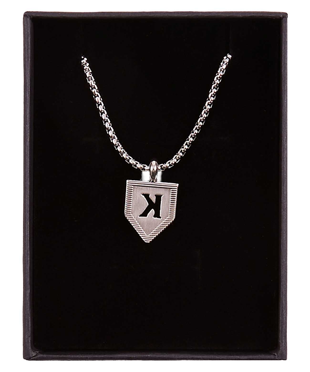 Silver pendant necklace with shield-shaped pendant engraved with sample letter K, displayed in black presentation box