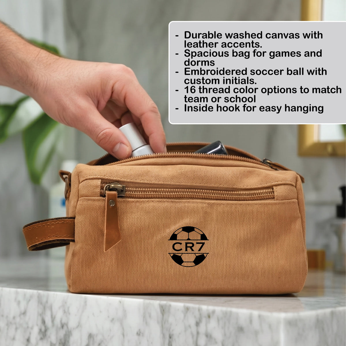 Personalized soccer toiletry bag in washed canvas with a leather handle and an embroidered soccer ball with custom initials, built for road games and college
