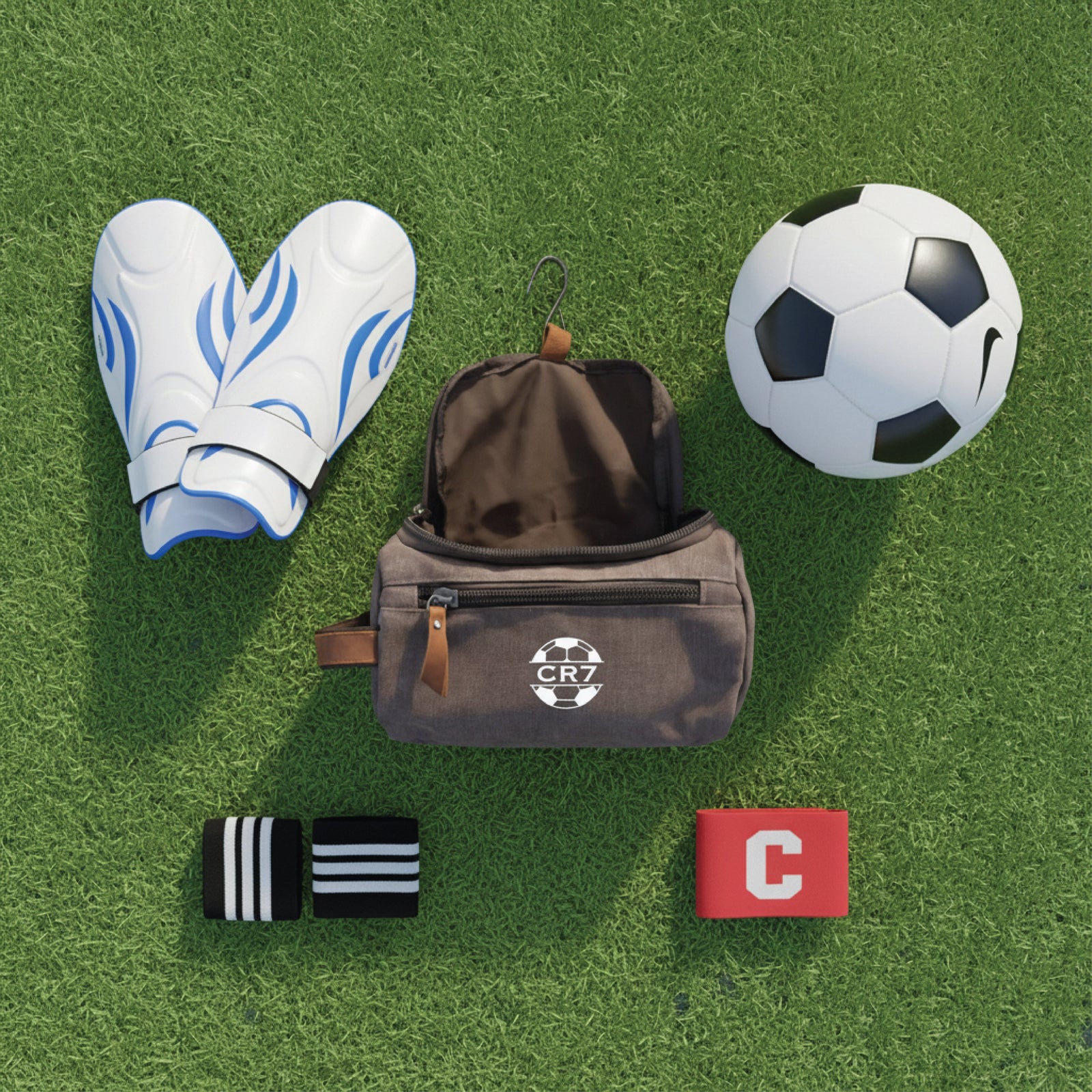Personalized soccer toiletry bag in washed canvas with a leather handle and an embroidered soccer ball with custom initials, built for road games and college