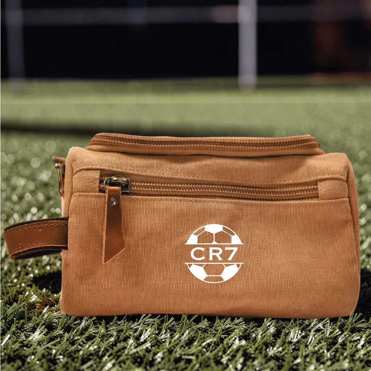 Personalized soccer toiletry bag in washed canvas with a leather handle and an embroidered soccer ball with custom initials, built for road games and college
