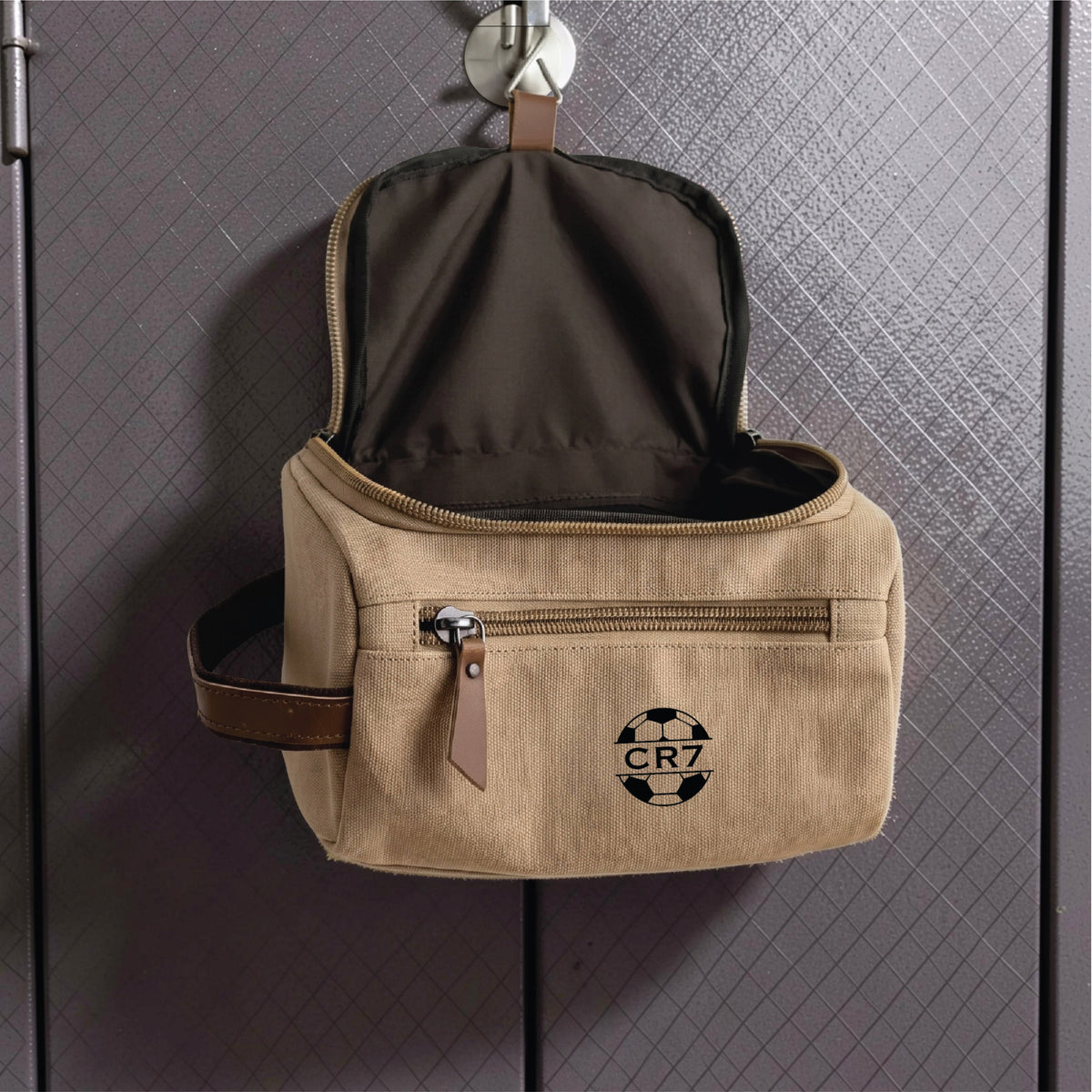 Personalized soccer toiletry bag in washed canvas with a leather handle and an embroidered soccer ball with custom initials, built for road games and college