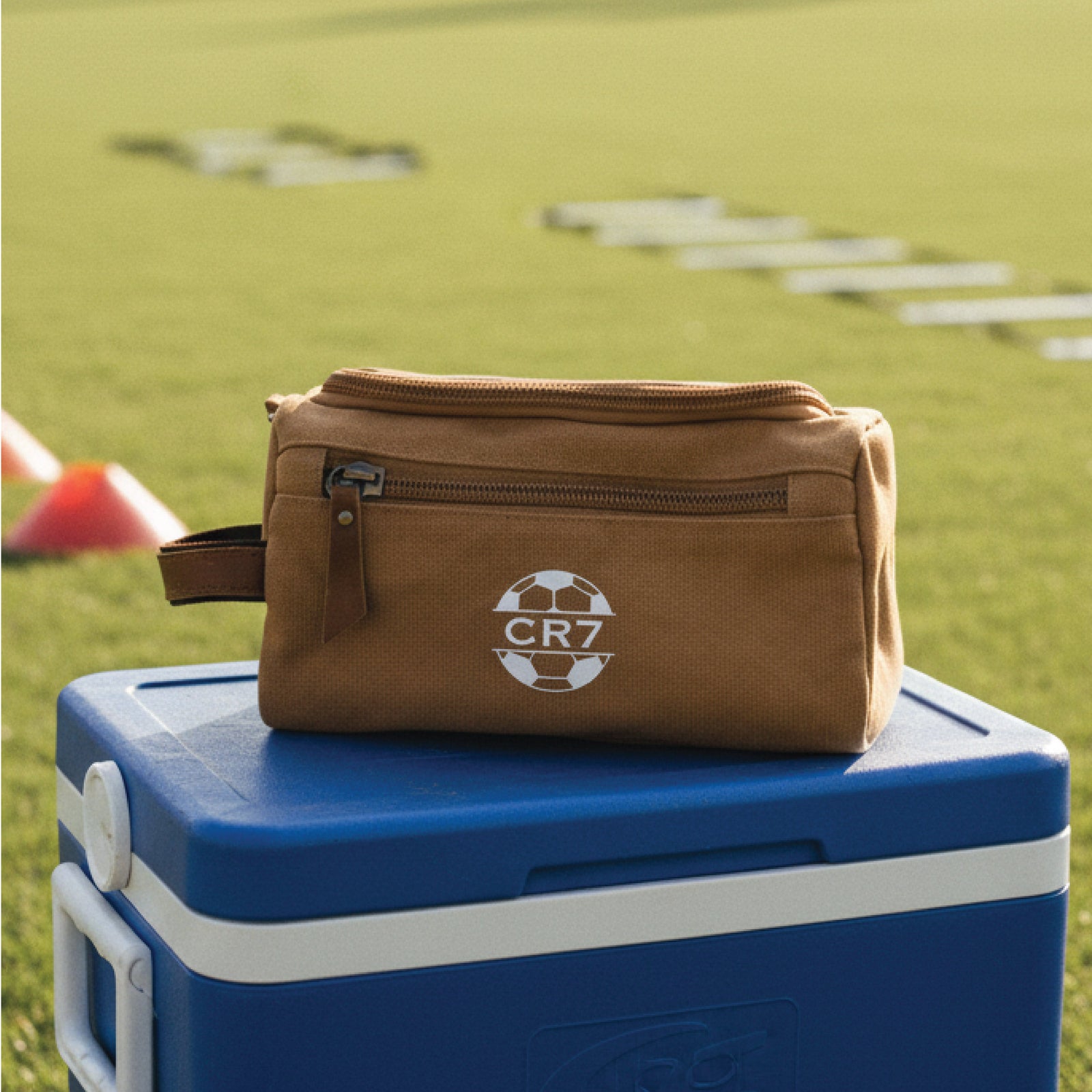Personalized soccer toiletry bag in washed canvas with a leather handle and an embroidered soccer ball with custom initials, built for road games and college