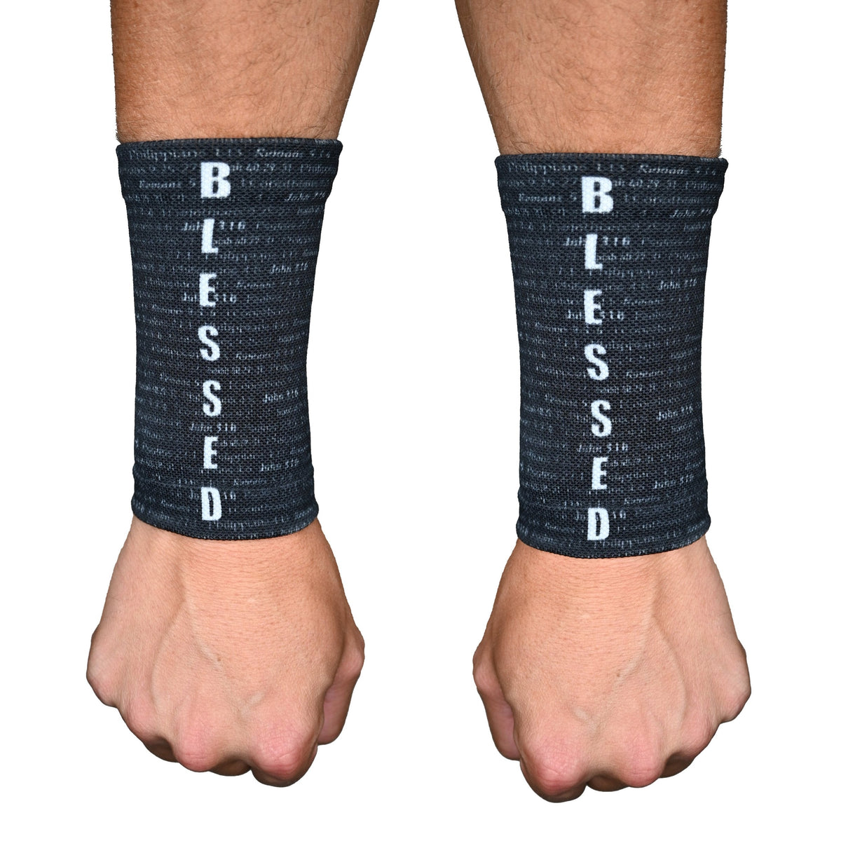 Pair of black wrist support sleeves with white "BLESSED" text running vertically down the front, worn on male model's wrists.