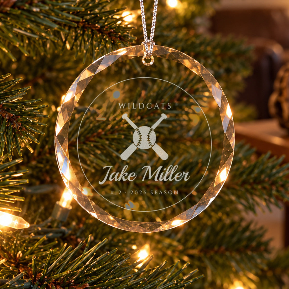 Personalized baseball ornament in faceted glass on a Christmas tree, engraved with crossed bats and a ball, WILDCATS, Jake Miller, #12 · 2026 SEASON