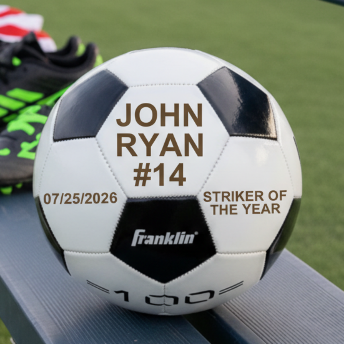 Personalized soccer ball with name and number John Ryan #14, a date and Striker of the Year engraved across three white panels
