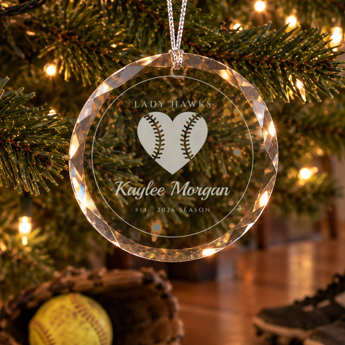 Personalized softball ornament in faceted glass on a Christmas tree, engraved with a softball heart, LADY HAWKS, Kaylee Morgan, #14 · 2026 SEASON