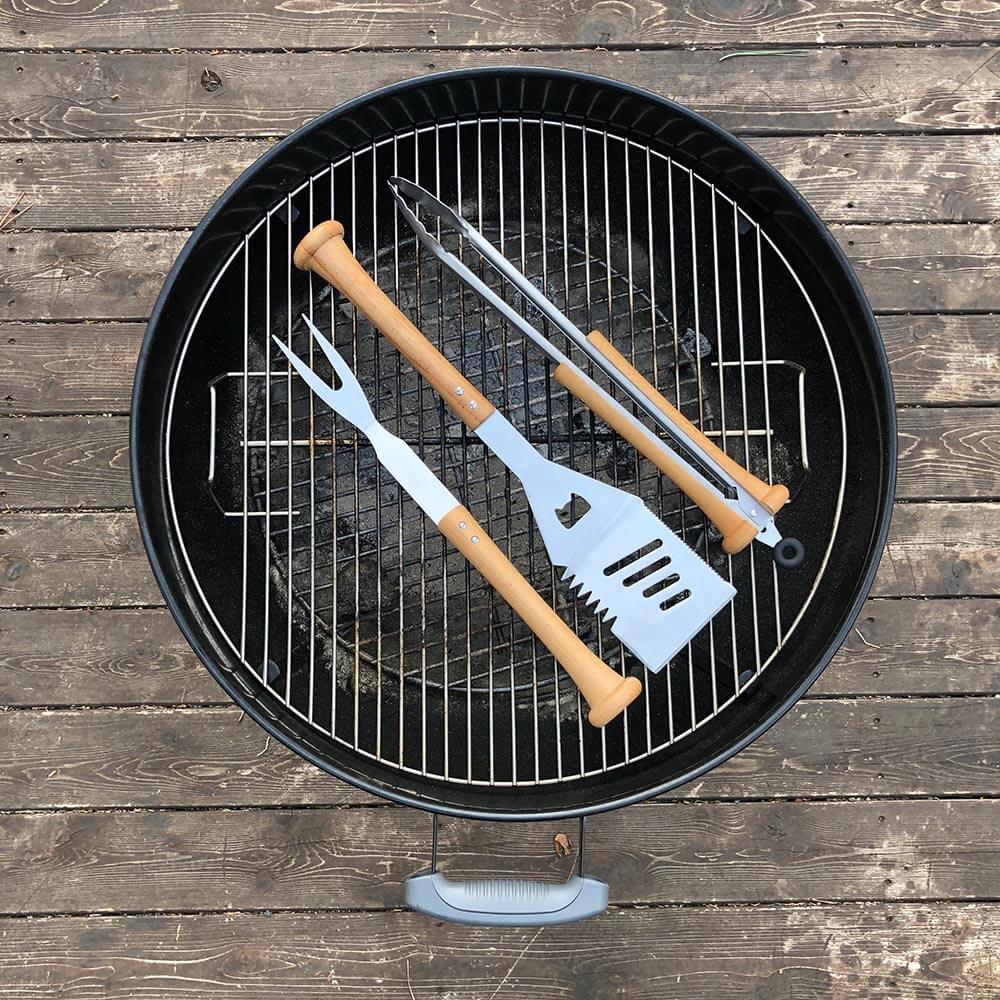 Triple Play combo set on a marble cutting board with sample 'SANDOVAL 98 / TO: MY HUBBY / BIG MIKE'S BBQ / IF YOU GRILL IT...' personalizations engraved on the handles